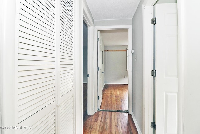 122 Oakwood Pl, Forked River, NJ 08731 - corridor with hardwood / wood-style floors, baseboards, and a textured ceiling