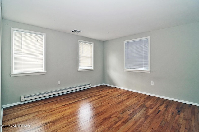 122 Oakwood Pl, Forked River, NJ 08731 - unfurnished room with a baseboard radiator, wood finished floors, and baseboards