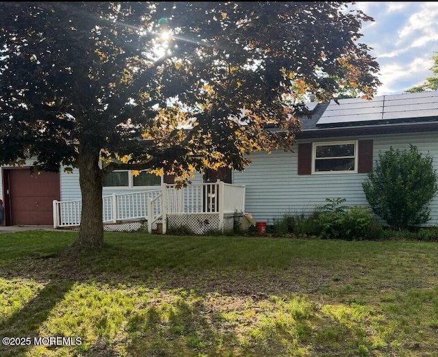9 Green Ridge Dr, Toms River, NJ 08757 - back of house with a yard, solar panels, and a garage