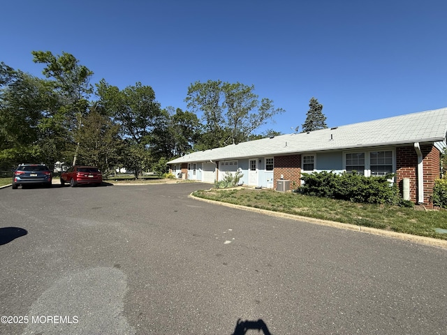1134A Argyll Cir, Lakewood, NJ 08701 - view of front facade with an attached garage, brick siding, and central AC