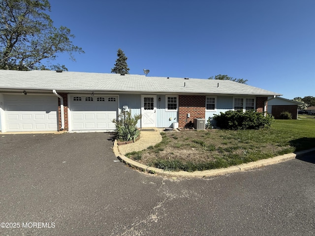 1134A Argyll Cir, Lakewood, NJ 08701 - ranch-style home featuring an attached garage, asphalt driveway, brick siding, and central AC