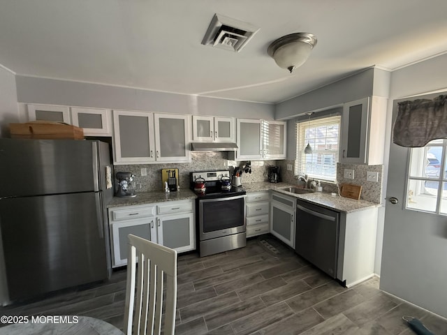 1134A Argyll Cir, Lakewood, NJ 08701 - kitchen with stainless steel appliances, under cabinet range hood, a sink, and healthy amount of natural light