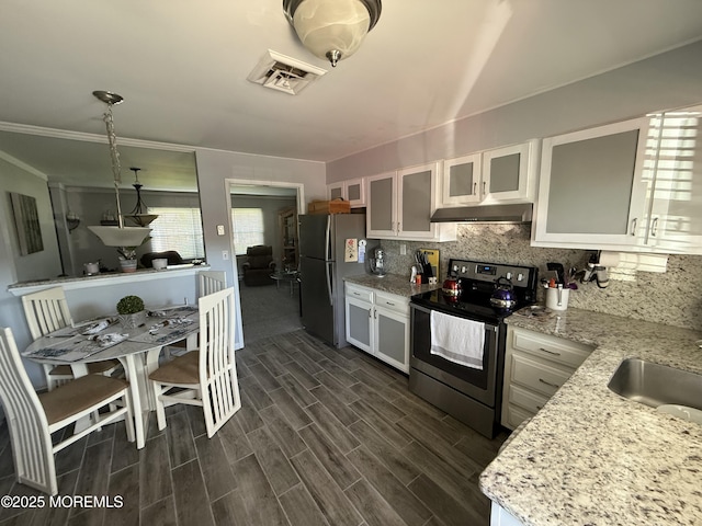 1134A Argyll Cir, Lakewood, NJ 08701 - kitchen with appliances with stainless steel finishes, under cabinet range hood, backsplash, white cabinetry, and glass insert cabinets