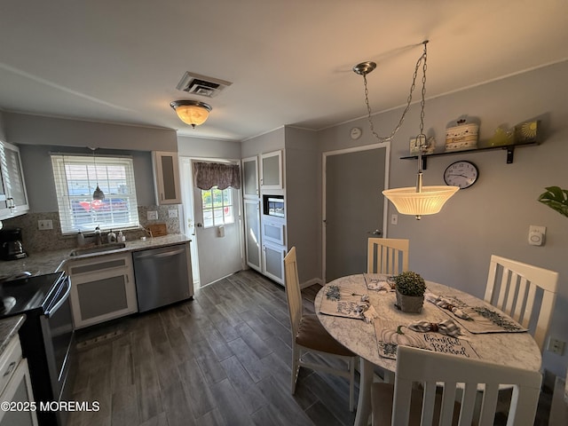 1134A Argyll Cir, Lakewood, NJ 08701 - kitchen featuring stainless steel appliances, a sink, decorative backsplash, dark wood-style floors, and glass insert cabinets