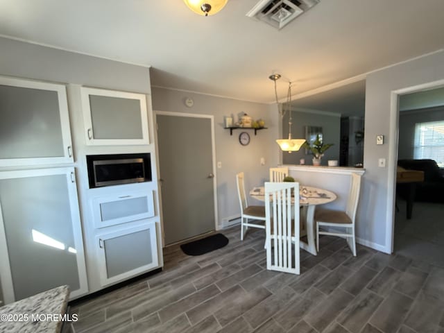 1134A Argyll Cir, Lakewood, NJ 08701 - dining space featuring baseboards, dark wood-type flooring, and ornamental molding