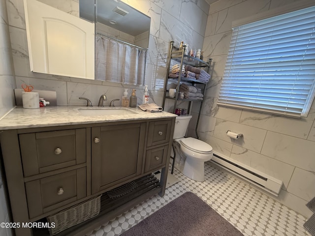 1134A Argyll Cir, Lakewood, NJ 08701 - full bath featuring a baseboard radiator, toilet, vanity, tile walls, and tile patterned floors