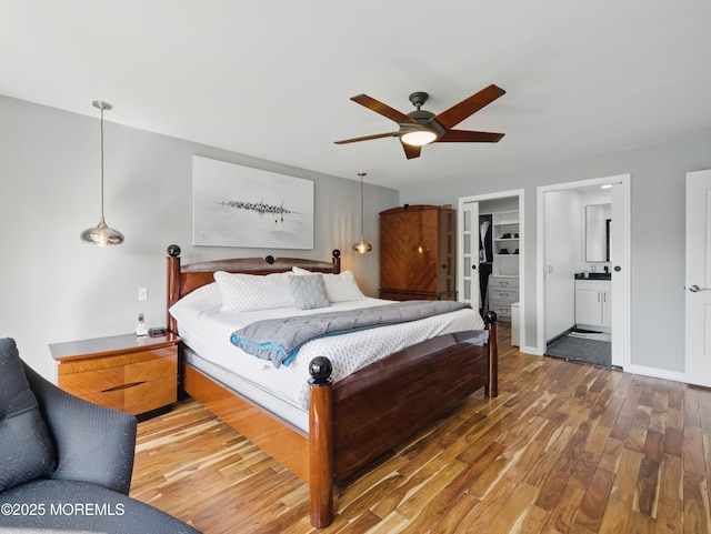 50 Locust Ct, Freehold, NJ 07728 - bedroom with wood finished floors, a walk in closet, connected bathroom, ceiling fan, and a closet
