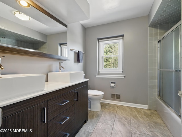 50 Locust Ct, Freehold, NJ 07728 - full bathroom featuring toilet, double vanity, bath / shower combo with glass door, baseboards, and marble look tile flooring