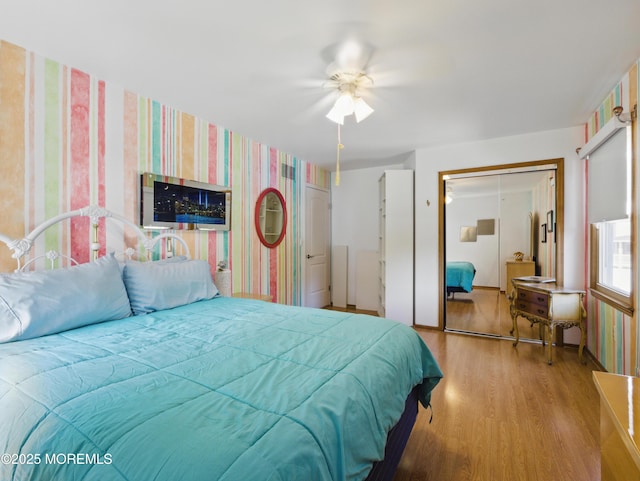 50 Locust Ct, Freehold, NJ 07728 - bedroom with wallpapered walls, wood finished floors, a ceiling fan, and a closet