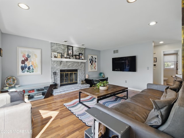 50 Locust Ct, Freehold, NJ 07728 - living room with wood finished floors, a fireplace, and recessed lighting