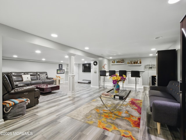 50 Locust Ct, Freehold, NJ 07728 - living room featuring a bar, light wood-type flooring, ornate columns, and recessed lighting