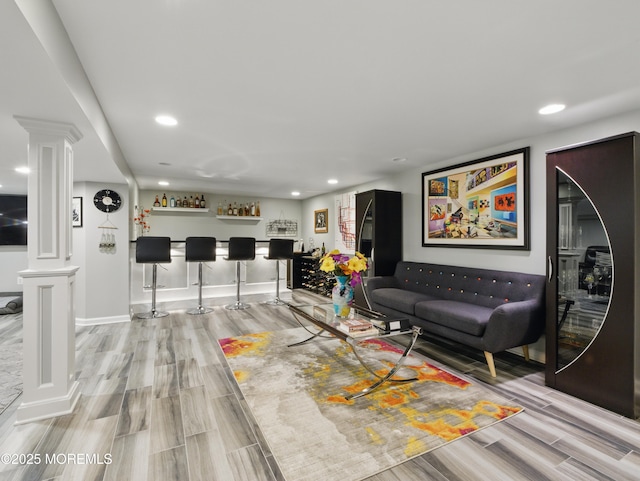 50 Locust Ct, Freehold, NJ 07728 - living area with decorative columns, a dry bar, wood finished floors, recessed lighting, and baseboards