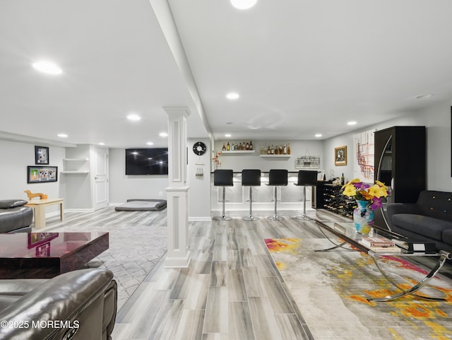 50 Locust Ct, Freehold, NJ 07728 - living room with ornate columns, a dry bar, wood tiled floors, recessed lighting, and baseboards
