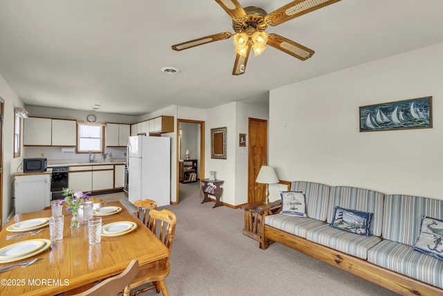 37 N 4th St, Surf City, NJ 08008 - dining space featuring light colored carpet, ceiling fan, and baseboards
