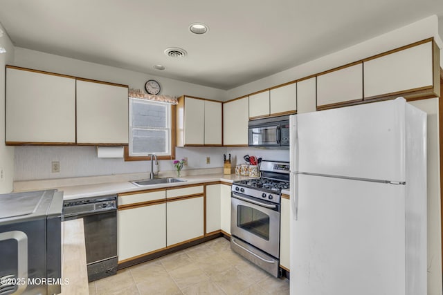 37 N 4th St, Surf City, NJ 08008 - kitchen with black appliances, a sink, light countertops, white cabinetry, and recessed lighting