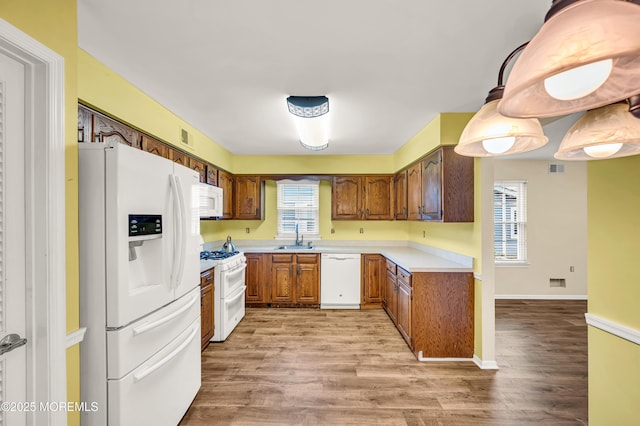 40 Everest Dr N, Brick, NJ 08724 - kitchen featuring white appliances, a sink, light wood-style flooring, and light countertops