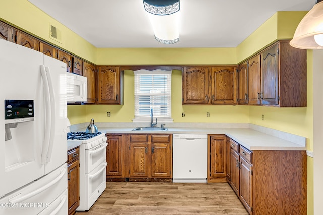 40 Everest Dr N, Brick, NJ 08724 - kitchen with white appliances, a sink, light wood-style flooring, light countertops, and brown cabinetry