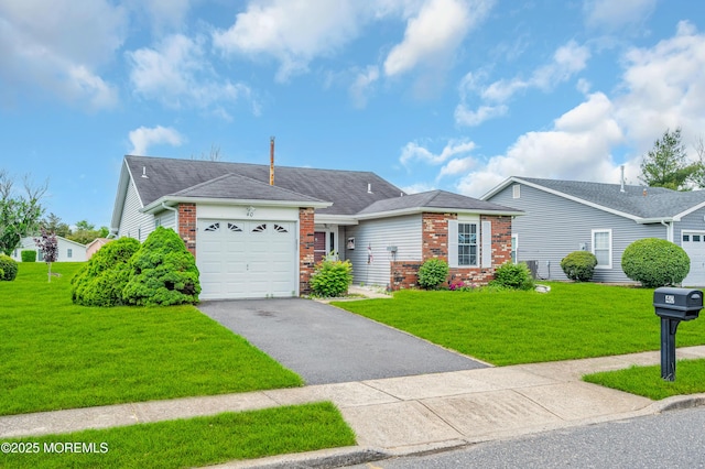 40 Everest Dr N, Brick, NJ 08724 - ranch-style home featuring brick siding, asphalt driveway, an attached garage, and a front lawn
