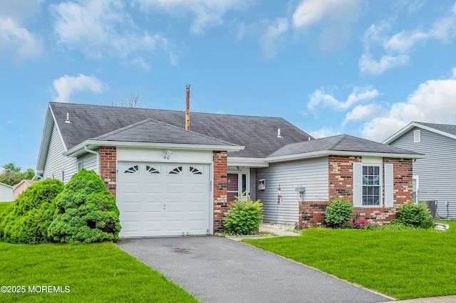 40 Everest Dr N, Brick, NJ 08724 - ranch-style home featuring a garage, asphalt driveway, brick siding, and a front lawn