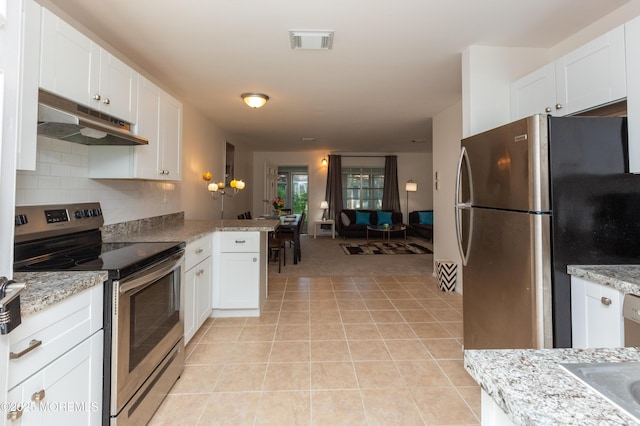 65C Dorchester Dr, Lakewood, NJ 08701 - kitchen with under cabinet range hood, stainless steel appliances, white cabinetry, light tile patterned flooring, and decorative backsplash