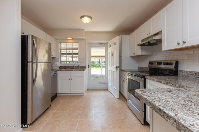 65C Dorchester Dr, Lakewood, NJ 08701 - kitchen featuring appliances with stainless steel finishes, under cabinet range hood, white cabinetry, backsplash, and light tile patterned floors