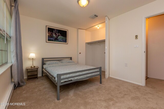 65C Dorchester Dr, Lakewood, NJ 08701 - bedroom with light carpet, baseboard heating, a closet, and a walk in closet