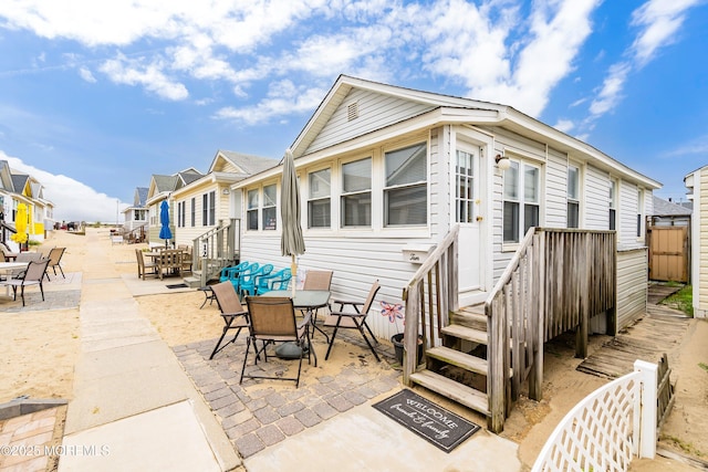 10 Brunswick Place, Point Pleasant Beach, NJ 08742 - rear view of house featuring outdoor dining space, a patio, and a residential view
