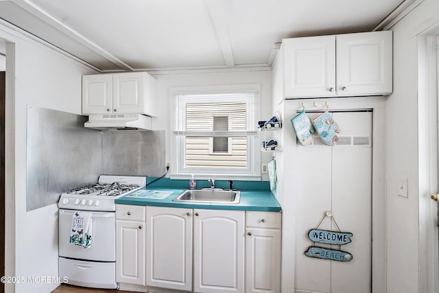 10 Brunswick Place, Point Pleasant Beach, NJ 08742 - kitchen with white gas stove, a sink, under cabinet range hood, and white cabinets