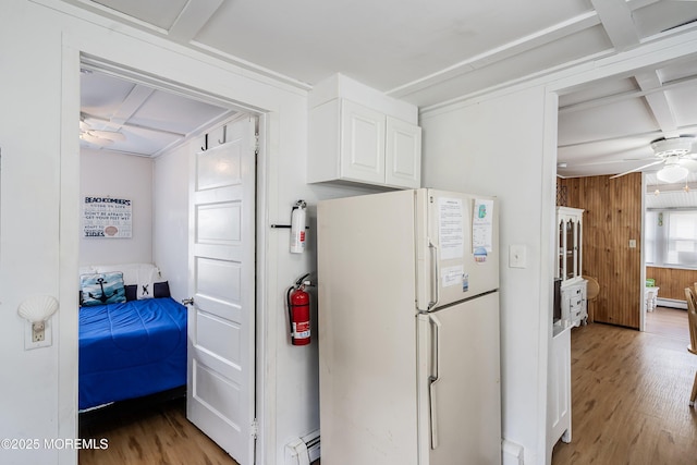 10 Brunswick Place, Point Pleasant Beach, NJ 08742 - kitchen featuring freestanding refrigerator, a ceiling fan, light wood-type flooring, white cabinets, and baseboard heating