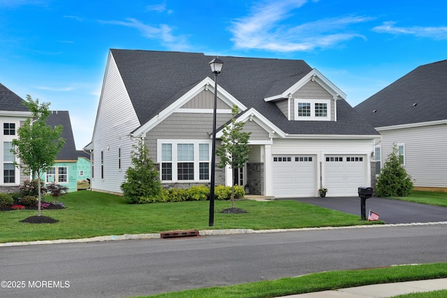 69 Starlight Dr, Monroe, NJ 08831 - view of front of property featuring asphalt driveway, a front lawn, stone siding, a garage, and a shingled roof
