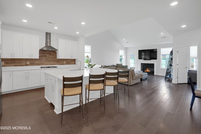 69 Starlight Dr, Monroe, NJ 08831 - kitchen with wall chimney range hood, a sink, a breakfast bar, healthy amount of natural light, and recessed lighting