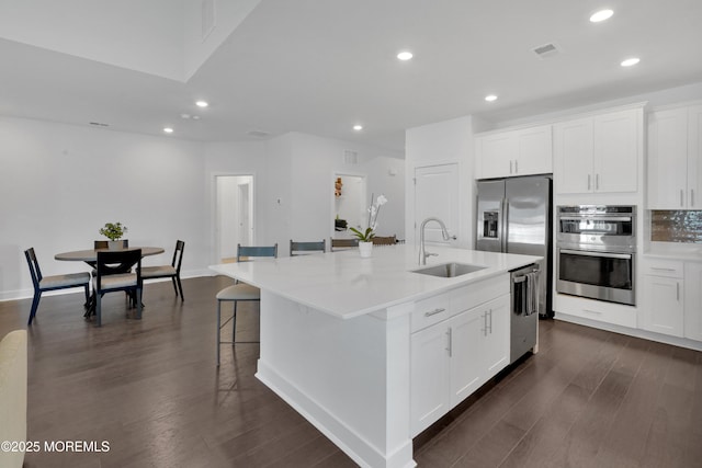 69 Starlight Dr, Monroe, NJ 08831 - kitchen with a sink, stainless steel appliances, recessed lighting, dark wood-style flooring, and a kitchen island with sink