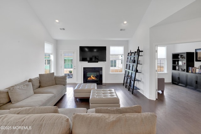 69 Starlight Dr, Monroe, NJ 08831 - living area featuring plenty of natural light, dark wood-style flooring, a fireplace with flush hearth, recessed lighting, and high vaulted ceiling
