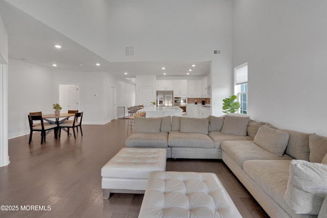 69 Starlight Dr, Monroe, NJ 08831 - living area with recessed lighting, a high ceiling, dark wood-style flooring, and baseboards