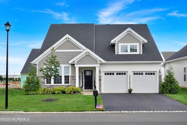 69 Starlight Dr, Monroe, NJ 08831 - view of front of home featuring asphalt driveway, a front lawn, a garage, stone siding, and a shingled roof