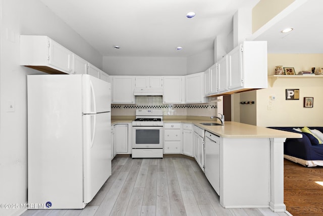 2060 Benjamin Cir, Wall, NJ 07719 - kitchen with white appliances, under cabinet range hood, light countertops, a peninsula, and recessed lighting