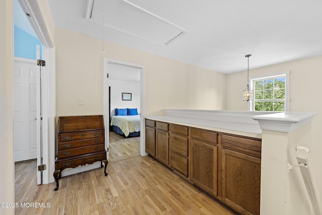 2060 Benjamin Cir, Wall, NJ 07719 - kitchen with light wood-style flooring, brown cabinetry, pendant lighting, and light countertops