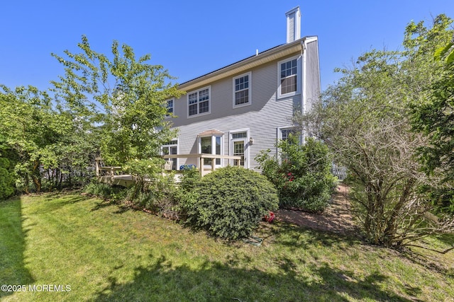 2060 Benjamin Cir, Wall, NJ 07719 - rear view of house with a lawn, a chimney, and a deck
