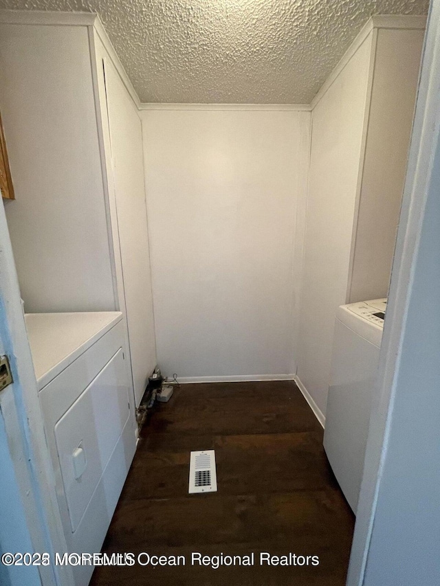 21 Citation St, Howell, NJ 07731 - laundry area featuring dark wood finished floors, a textured ceiling, independent washer and dryer, and baseboards