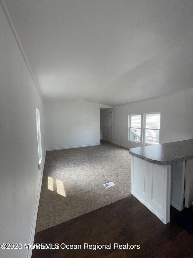 21 Citation St, Howell, NJ 07731 - unfurnished room featuring vaulted ceiling, baseboards, dark wood-style flooring, and dark colored carpet