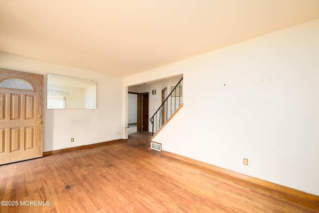 644 Monmouth Ave, Kenilworth, NJ 07033 - empty room with wood finished floors, stairway, and baseboards