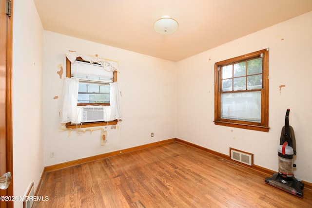 644 Monmouth Ave, Kenilworth, NJ 07033 - spare room with plenty of natural light, wood finished floors, and cooling unit