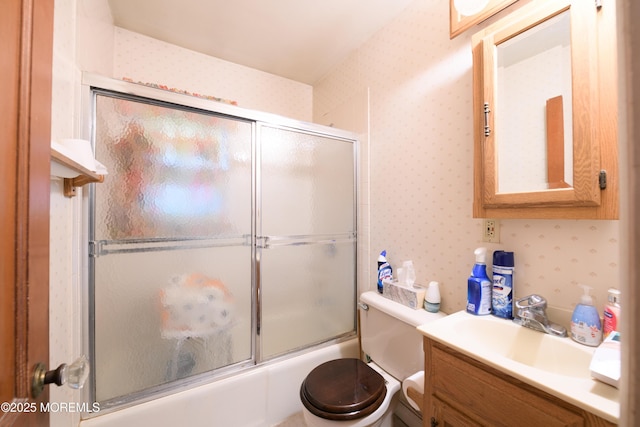 644 Monmouth Ave, Kenilworth, NJ 07033 - full bathroom with wallpapered walls, vanity, toilet, and combined bath / shower with glass door
