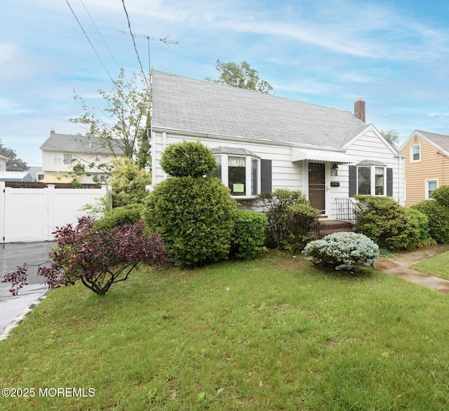 644 Monmouth Ave, Kenilworth, NJ 07033 - new england style home with a chimney and roof with shingles