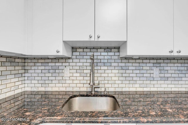 1320 State Route 71 Unit 202, Belmar, NJ 07719 - kitchen view of a sink, white cabinets, dark stone counters, and decorative backsplash