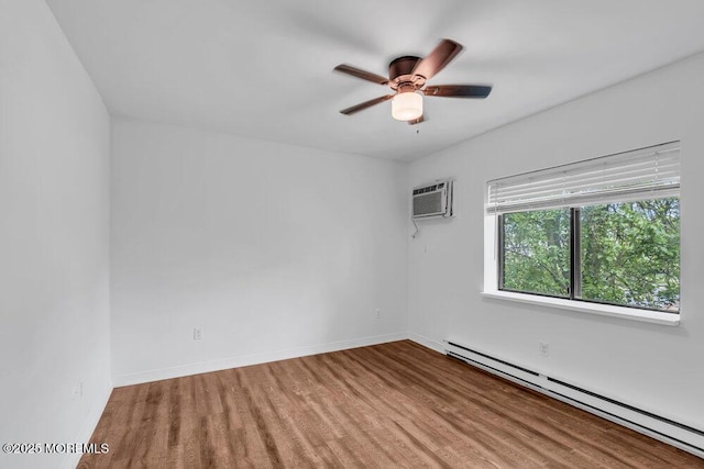 1320 State Route 71 Unit 202, Belmar, NJ 07719 - spare room featuring a baseboard radiator, wood finished floors, ceiling fan, a wall mounted AC, and baseboards