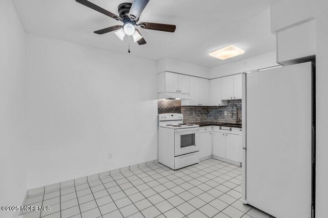 1320 State Route 71 Unit 202, Belmar, NJ 07719 - kitchen with white appliances, dark countertops, a ceiling fan, tasteful backsplash, and white cabinets