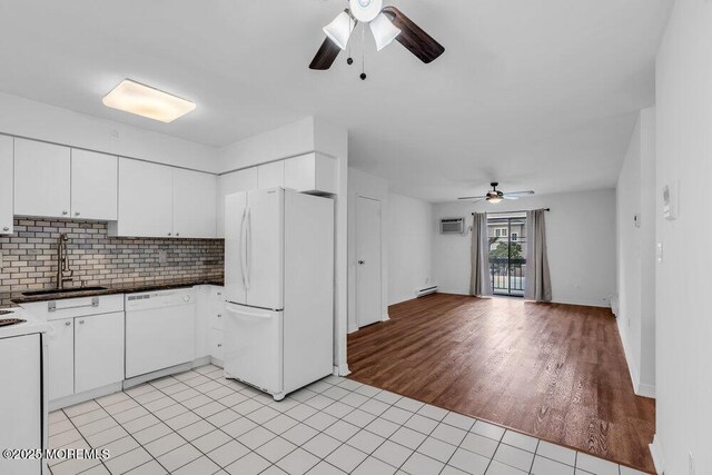 1320 State Route 71 Unit 202, Belmar, NJ 07719 - kitchen featuring white appliances, a sink, a ceiling fan, baseboard heating, and backsplash