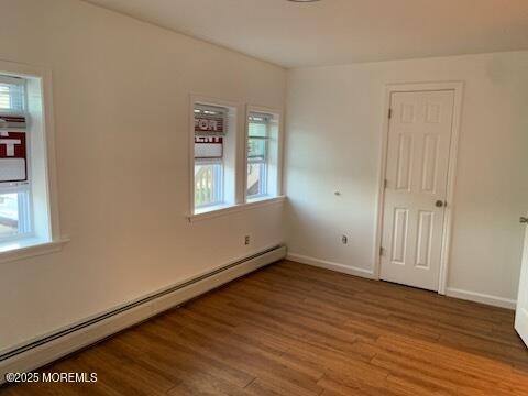 128 Hamilton Ave, Seaside Heights, NJ 08751 - empty room with baseboard heating, plenty of natural light, and wood finished floors