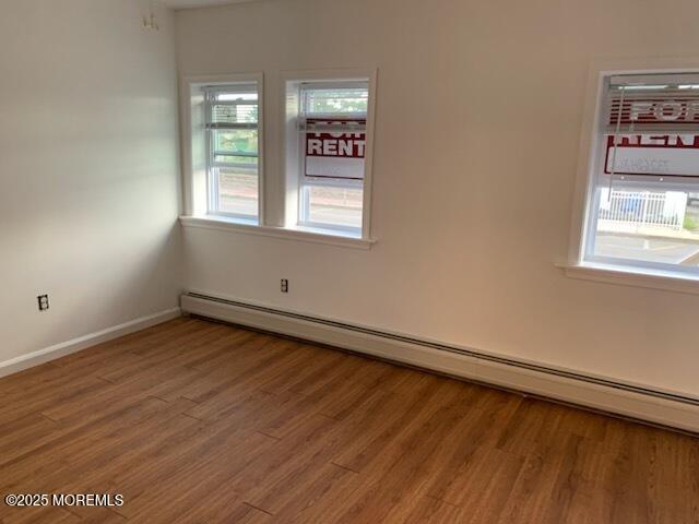 128 Hamilton Ave, Seaside Heights, NJ 08751 - empty room with wood finished floors and baseboard heating